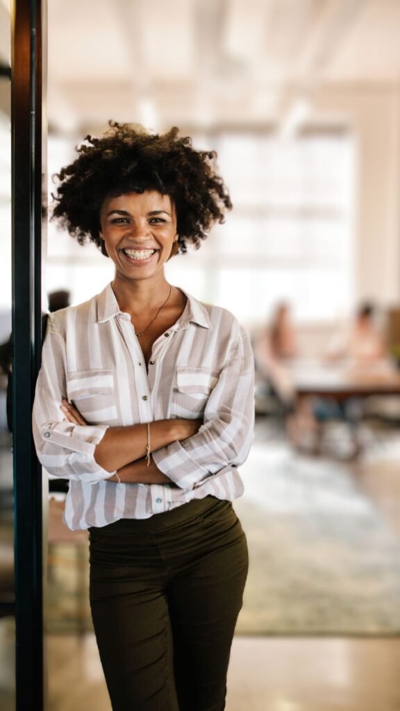 A luxury concierge agent smiling at her office.