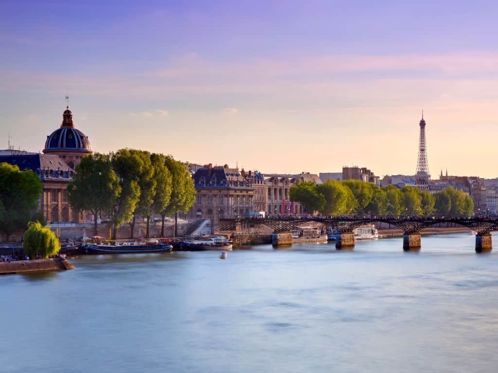 The elegant allure of Paris, mirrored in the illuminated Eiffel Tower reflected on the Seine River