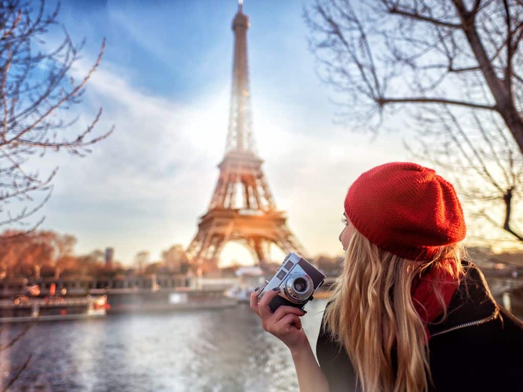 Enthusiastic tourists admiring the iconic Eiffel Tower, a symbol of Parisian wonders