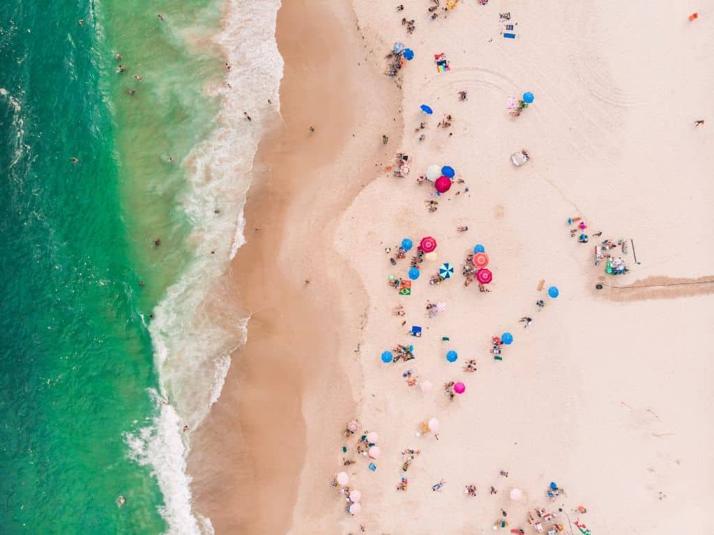 People enjoying the unique and amazing Copacabana's beach in Rio de Janeiro, Brazil.