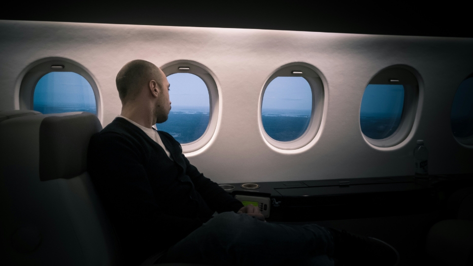 Plane Tickets to Rio de Janeiro_ A Concierge Guide for High-End Travelers Luxury traveler enjoying a First Class cabin, representing premium plane tickets to Rio de Janeiro