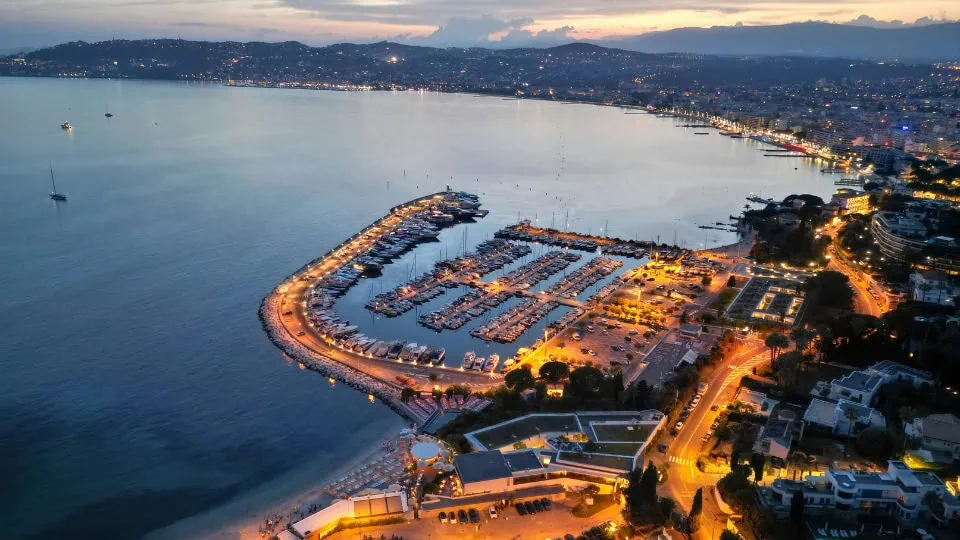 Aerial view of Cannes showing the marina, luxury yachts, and the French Riviera coastline, highlighting the setting of ILTM Cannes.