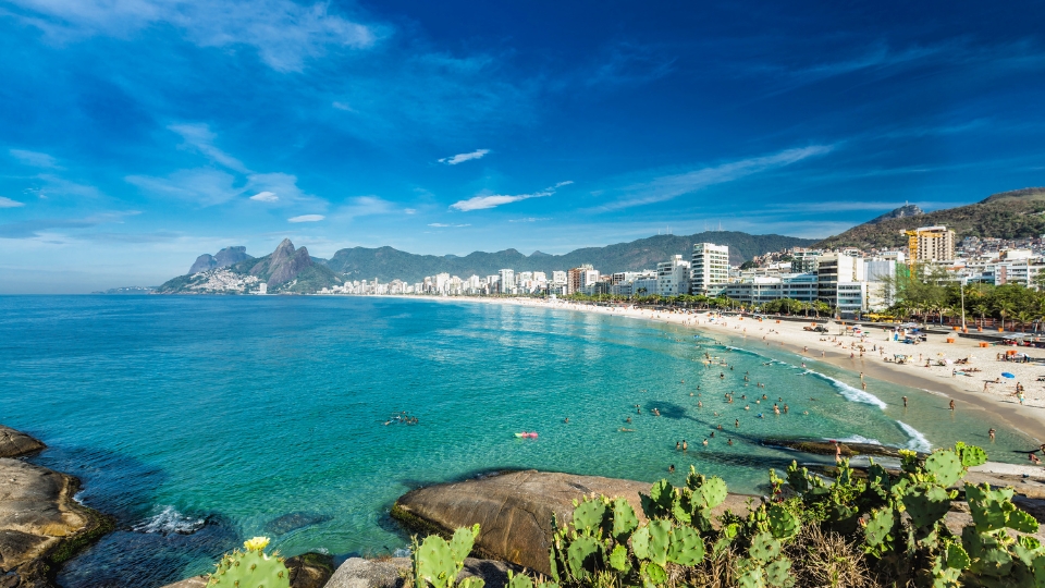 Ipanema Beach, rio de janeiro Beaches in Rio de Janeiro showing Ipanema Beach with Dois Irmãos mountains in the distance and calm ocean conditions