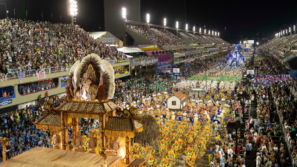 Carnival parade at the sambadrome (2) Nighttime carnival parade in the Sambadrome, Rio de Janeiro, featuring illuminated floats, dancers, and the grand scale of the avenue
