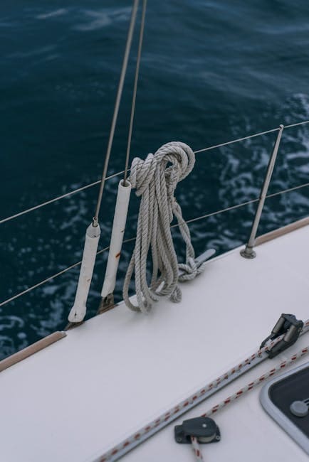 pexels-photo-7930898-7930898 Rope tied on a yacht deck railing with ocean in background, highlighting nautical themes.