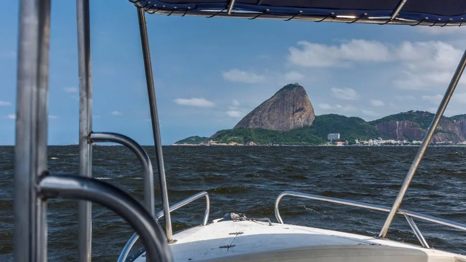 sugarloaf view from speedboat Speed boat rental in Rio de Janeiro cruising past Sugarloaf Mountain in Guanabara Bay, Brazil.