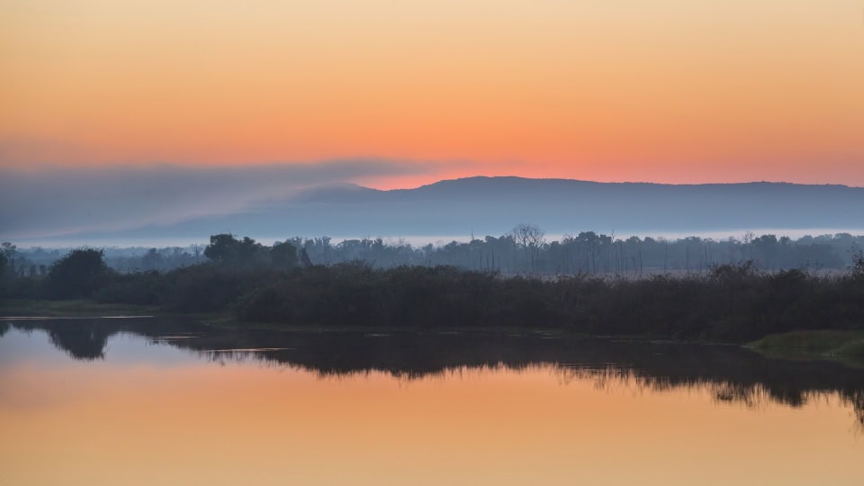 sunrise at pantanal Sunrise over the Pantanal wetlands reached via regional connections following flights to Brazil