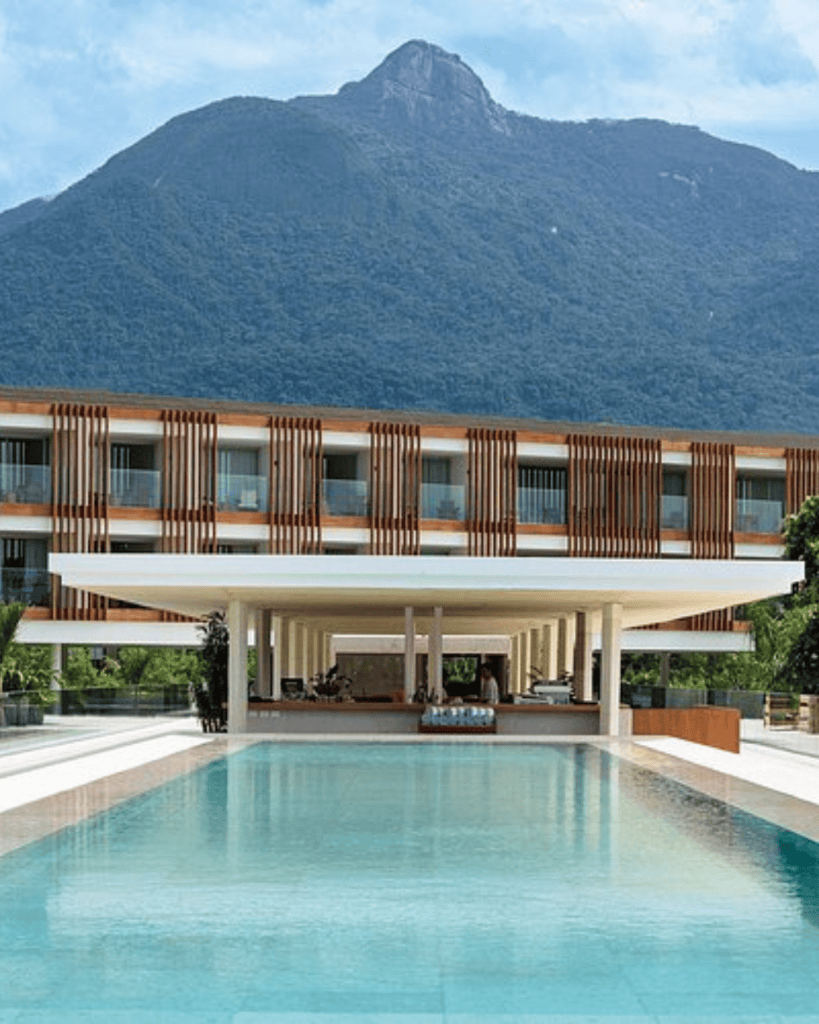 Fasano Angra dos Reis - Hotel Booking in Angra dos Reis Fasano hotel with pool and mountain view in the background.